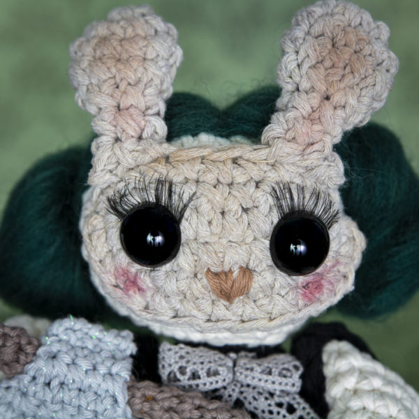 Portrait d'un amigurumi, figurine en crochet représentant Martha une petite fille au masque de lapin, imaginée et confectionnée à la main par les Mignonstres, une marque le Rat et l’Ours.